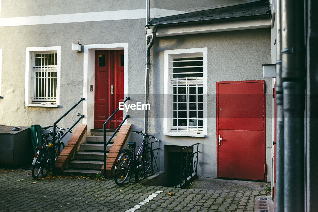 Bicycles by steps against house