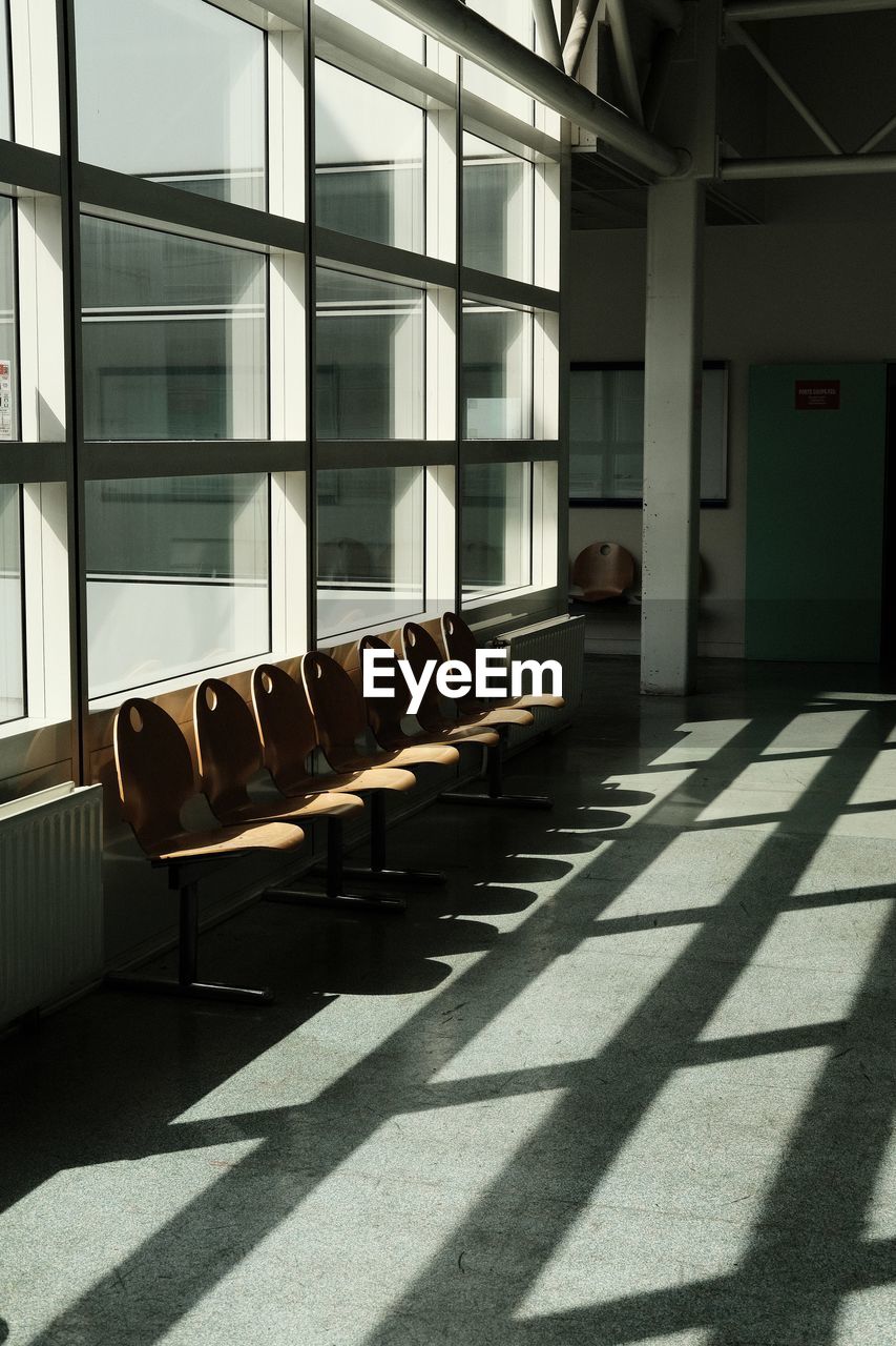 shadow, sunlight, architecture, indoors, seat, window, interior design, no people, empty, built structure, absence, chair, day, furniture, in a row, building, nature