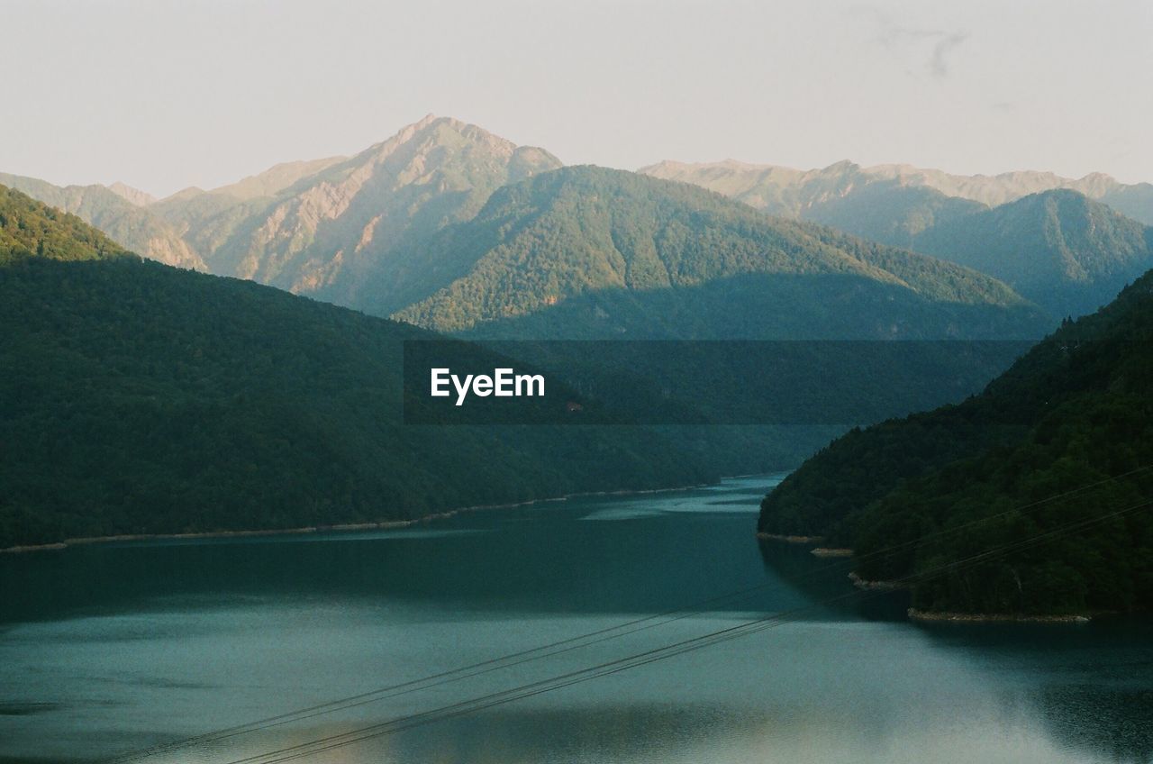 SCENIC VIEW OF RIVER AGAINST MOUNTAINS