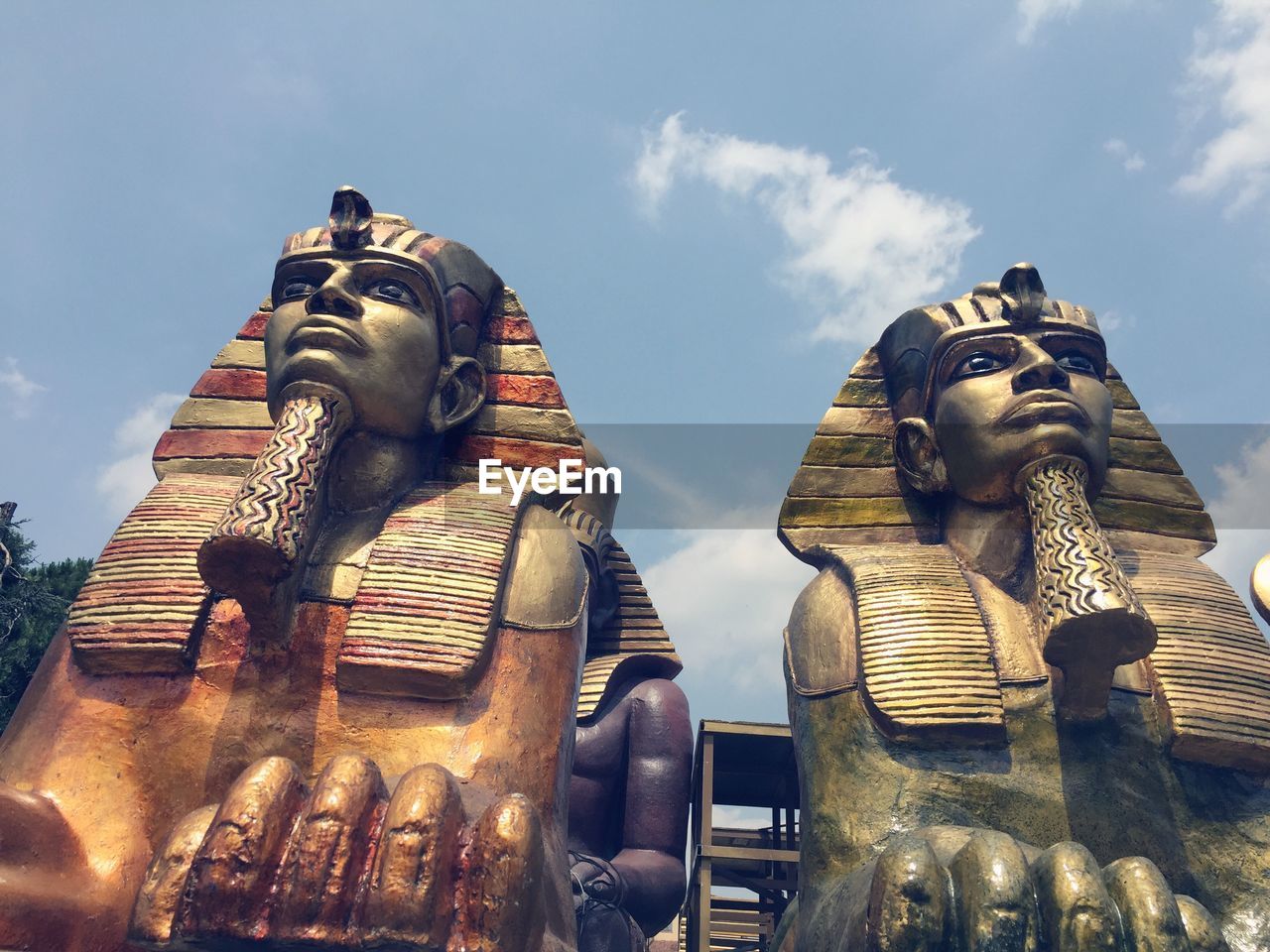 Low angle view of egyptian statues against the sky