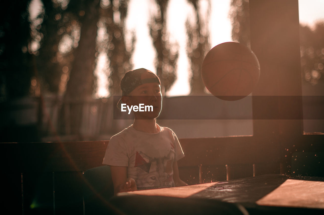 FULL LENGTH PORTRAIT OF BOY STANDING BY TABLE