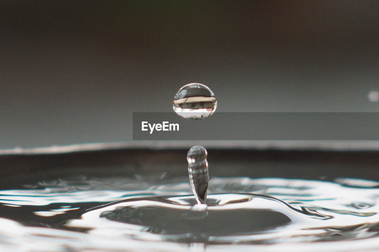 Close-up of splashing droplet of water in container