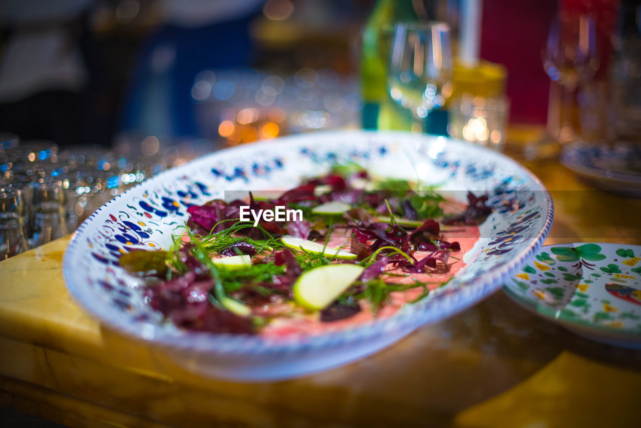 CLOSE-UP OF MEAL SERVED IN PLATE ON TABLE