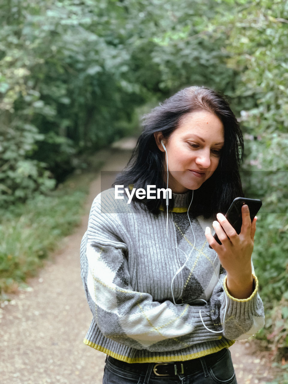 Young woman is walking in the park and talking to her friends with using video call.casual lifestyle