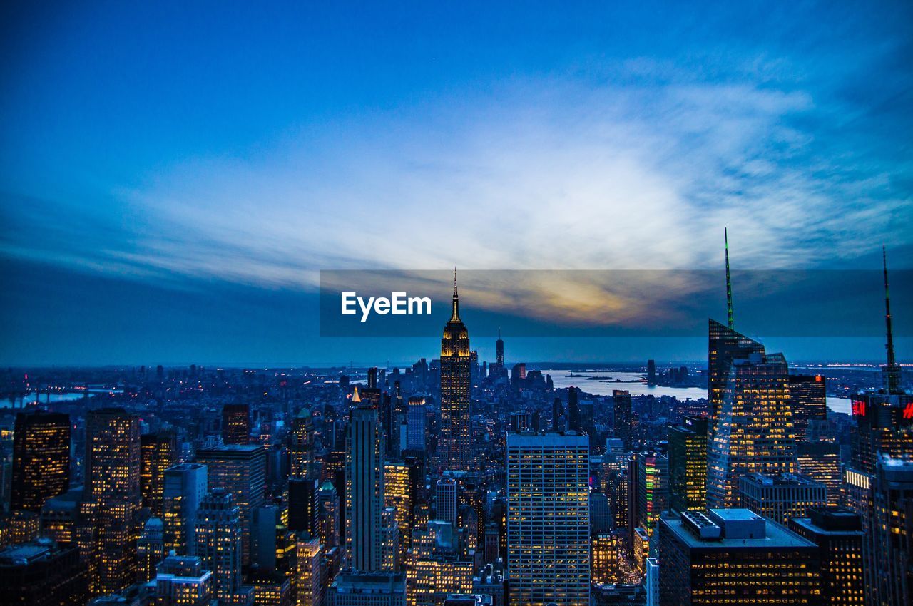 View of cityscape against cloudy sky