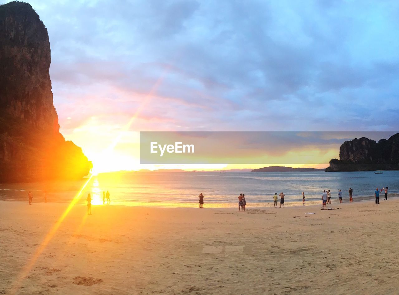 Scenic view of beach against cloudy sky