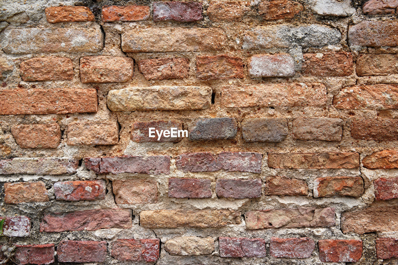 FULL FRAME SHOT OF BRICK WALL WITH RED STONE WALLS