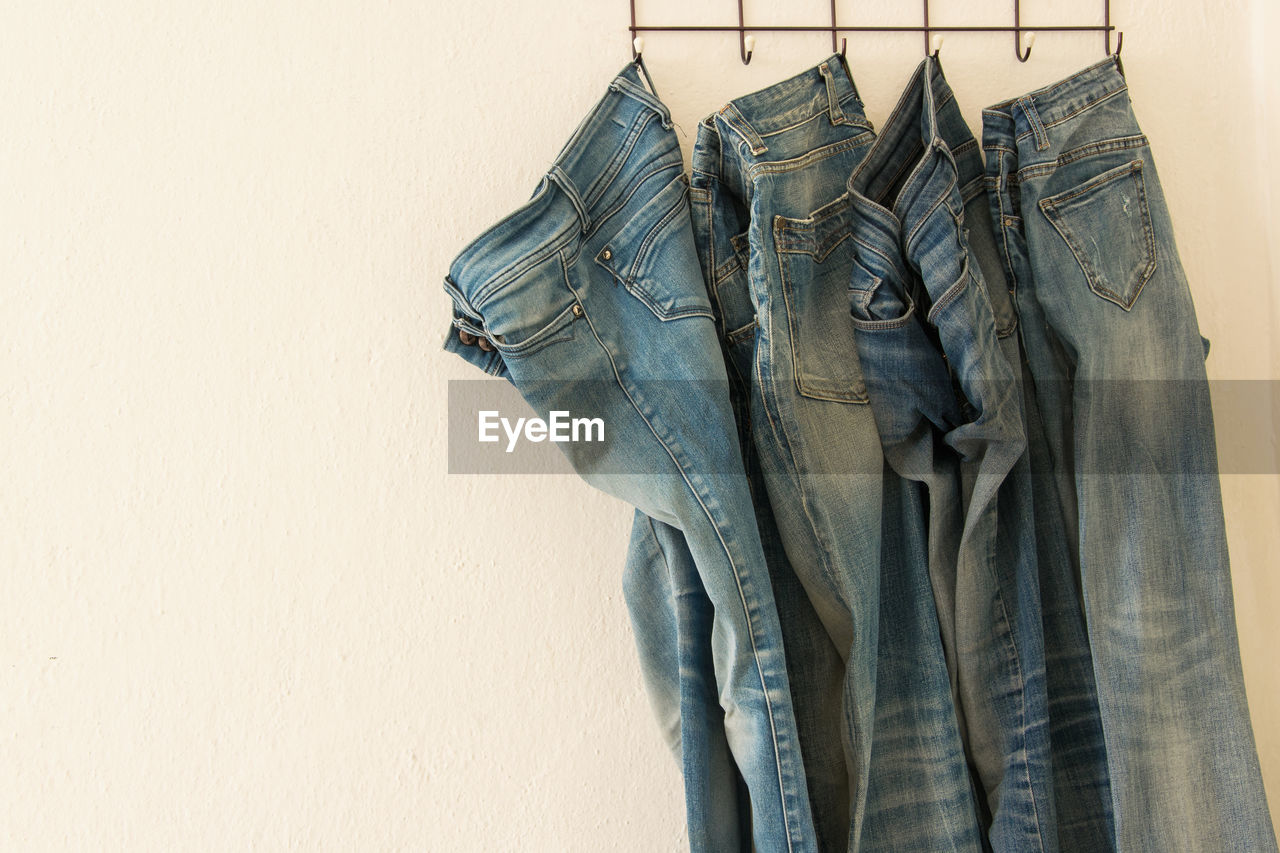 Close-up of jeans hanging from rack