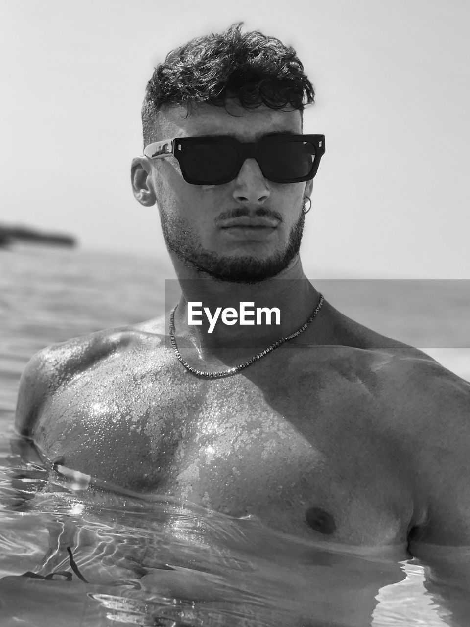 portrait of young man swimming in sea