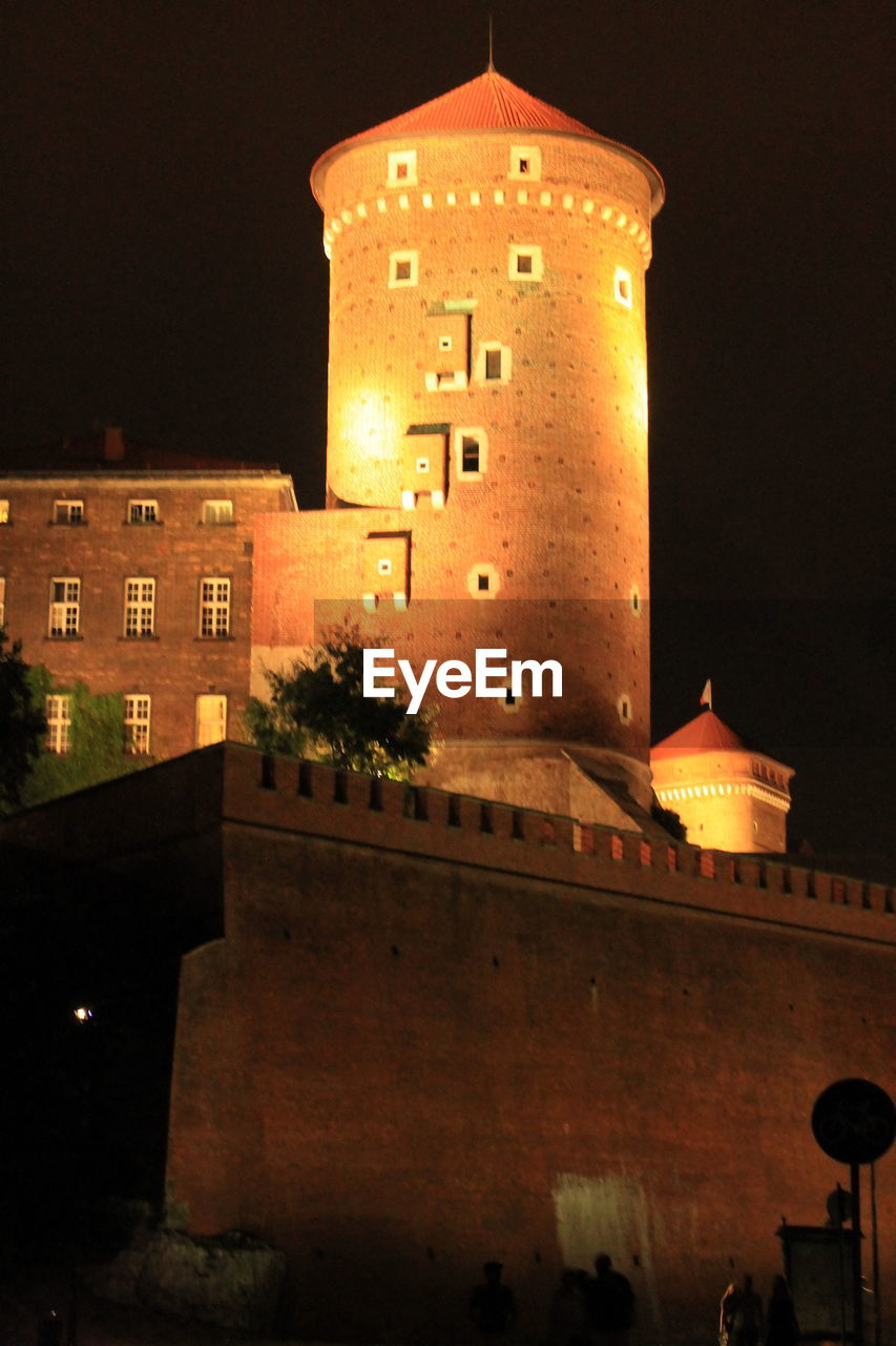 VIEW OF ILLUMINATED TOWER AT NIGHT