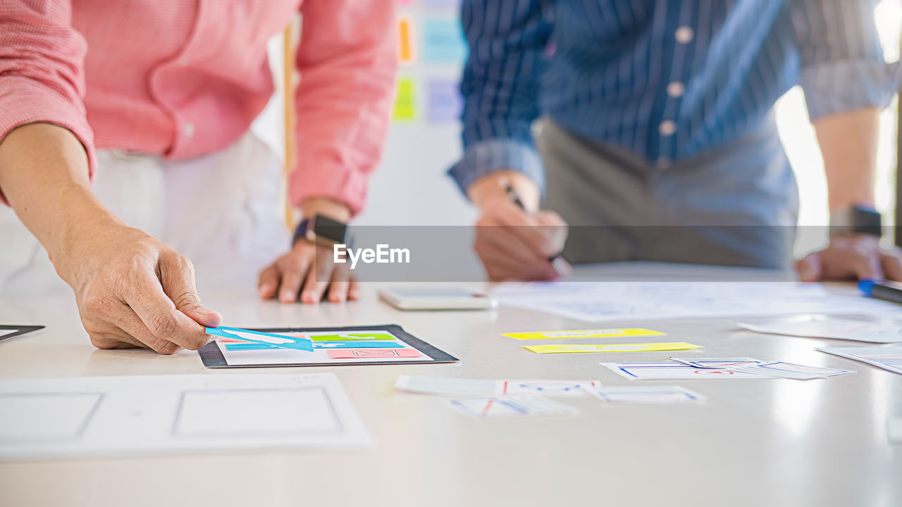 GROUP OF PEOPLE WORKING ON PAPER