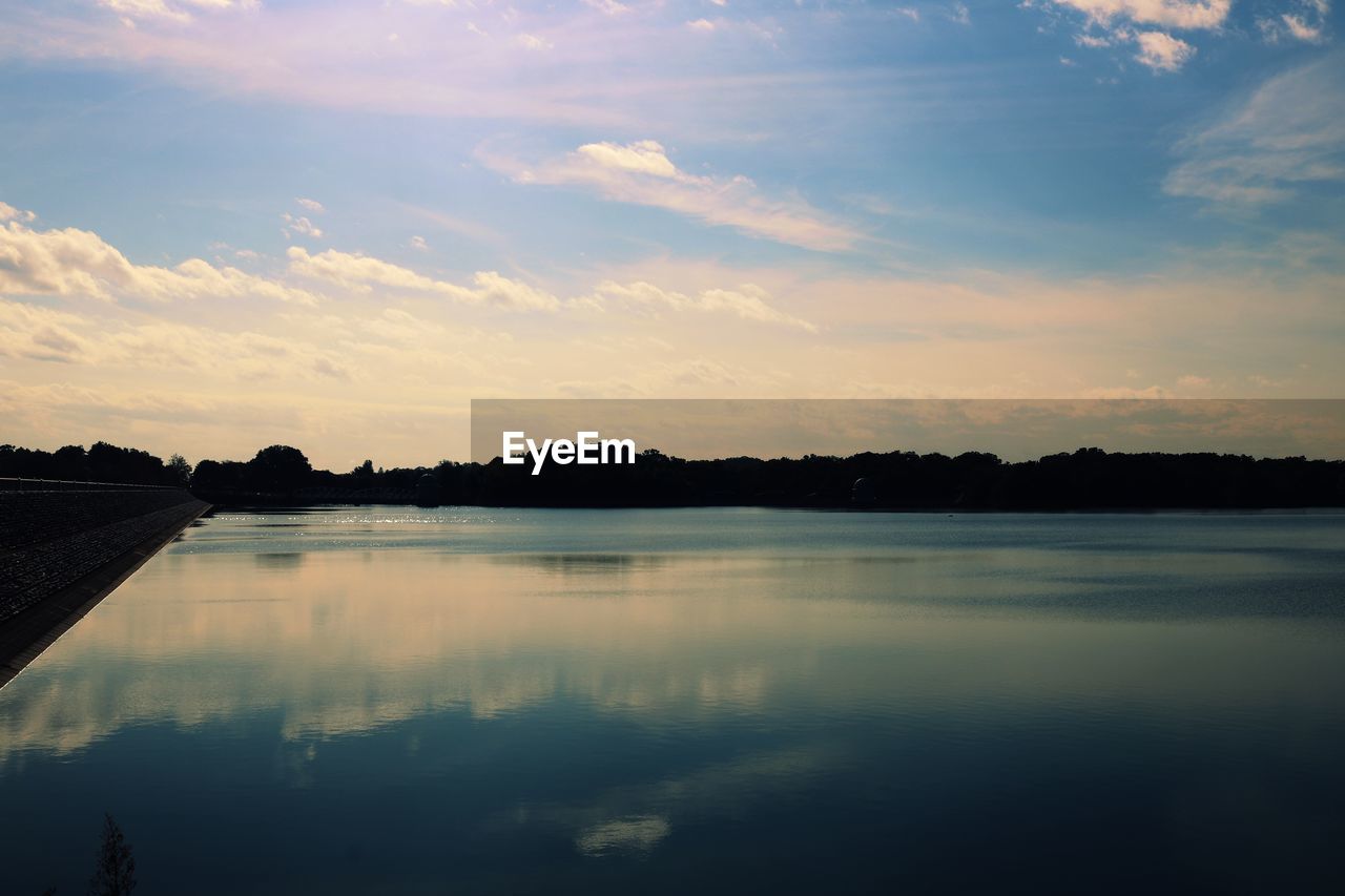 Scenic view of lake against sky during sunset