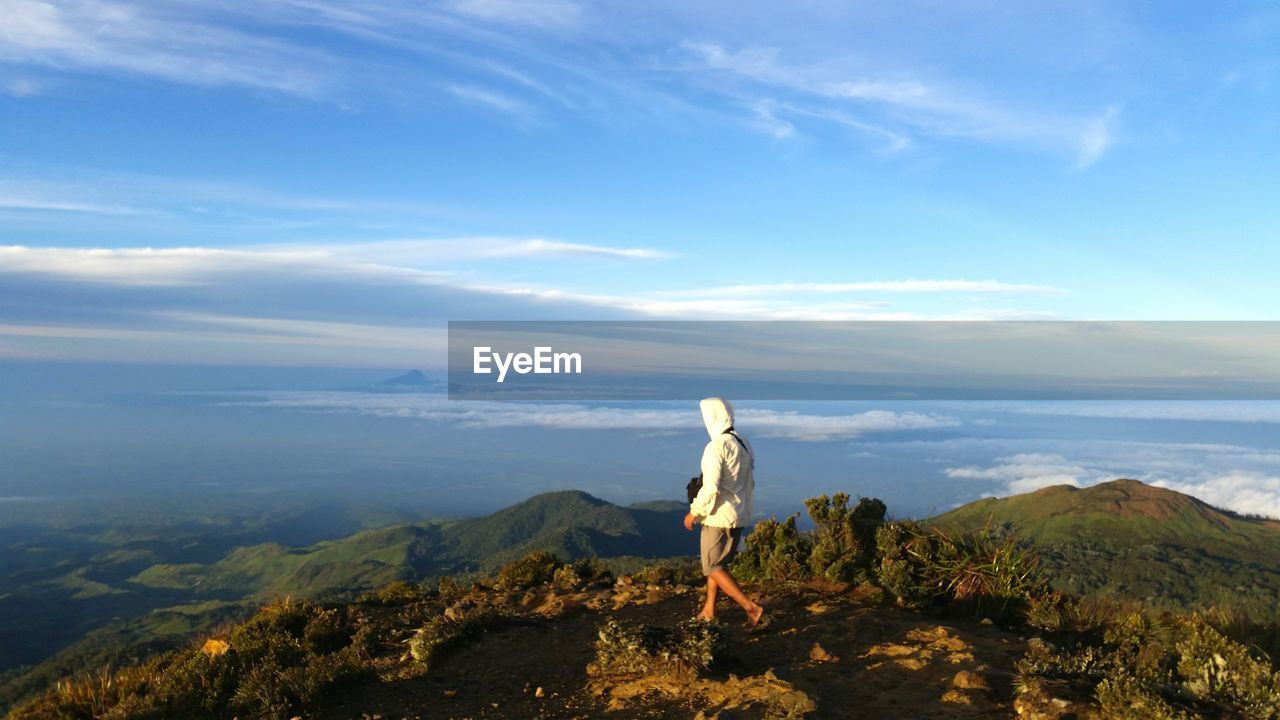 Rear view of man hiking on mount apo against sky