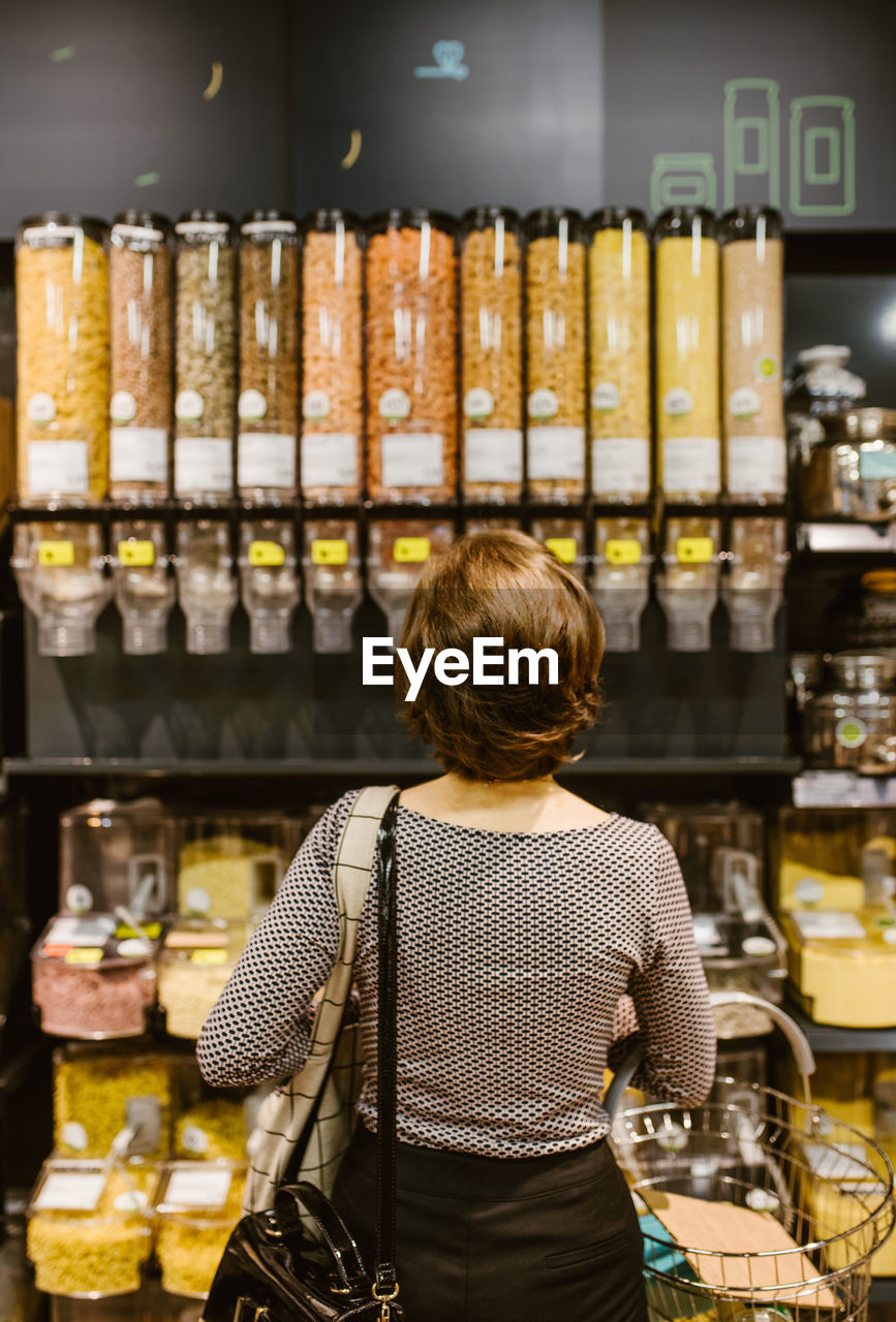 Rear view of woman standing in store