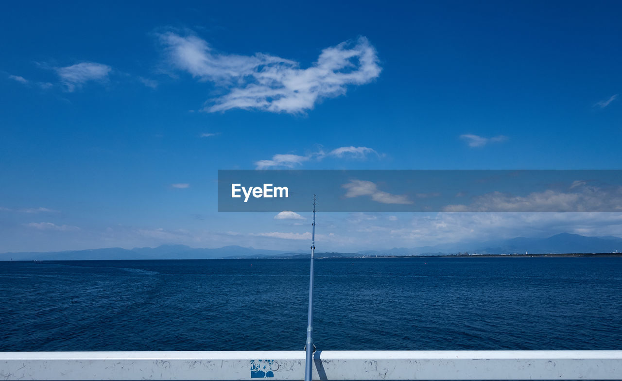 Scenic view of sea against blue sky