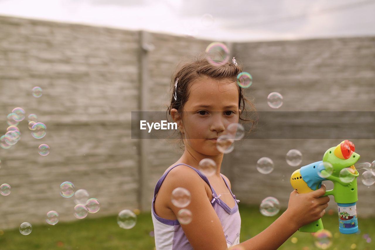 Girl playing with bubbles