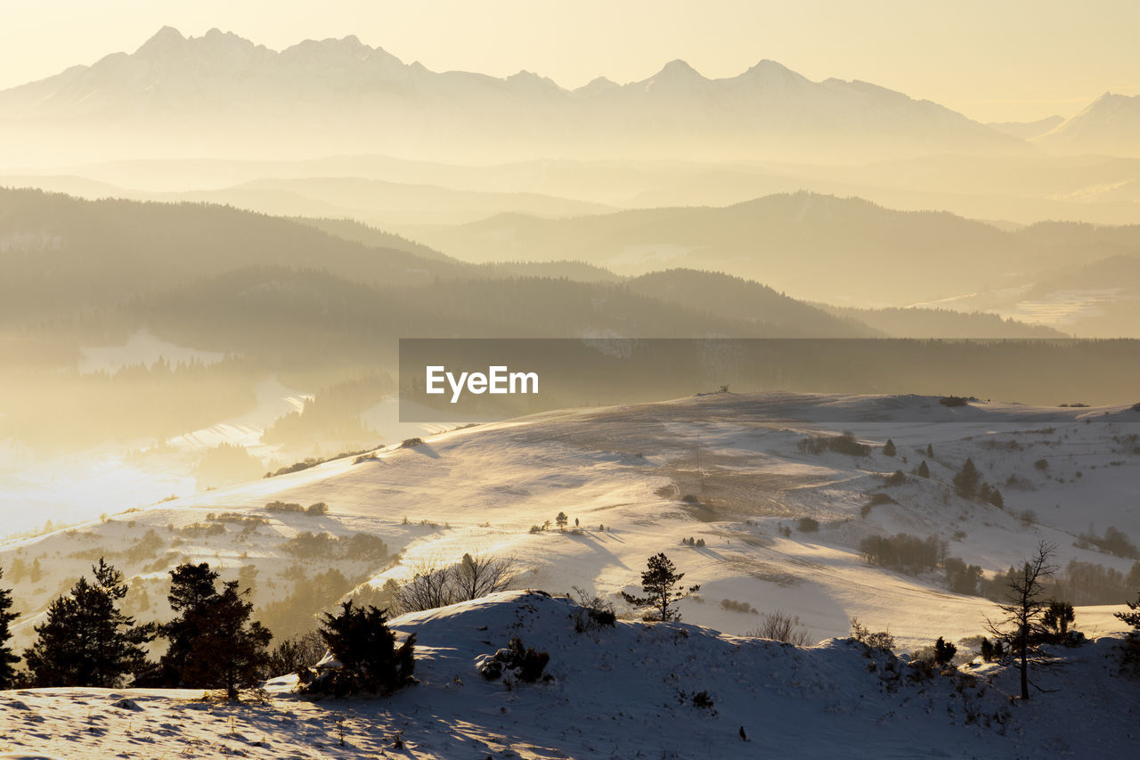 Scenic view of snow covered mountains against sky