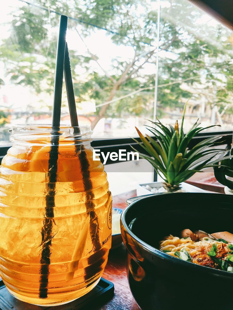 Close-up of food and peach tea served on table at restaurant