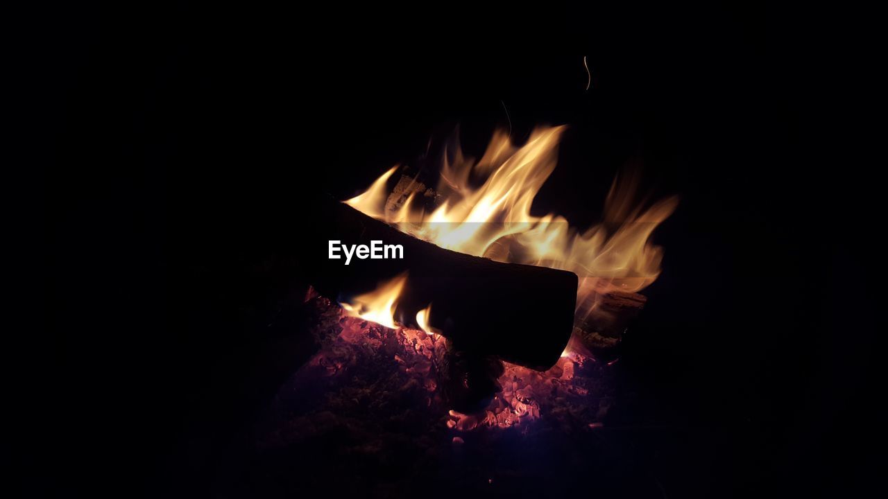 CLOSE-UP OF FIRE BURNING AT NIGHT