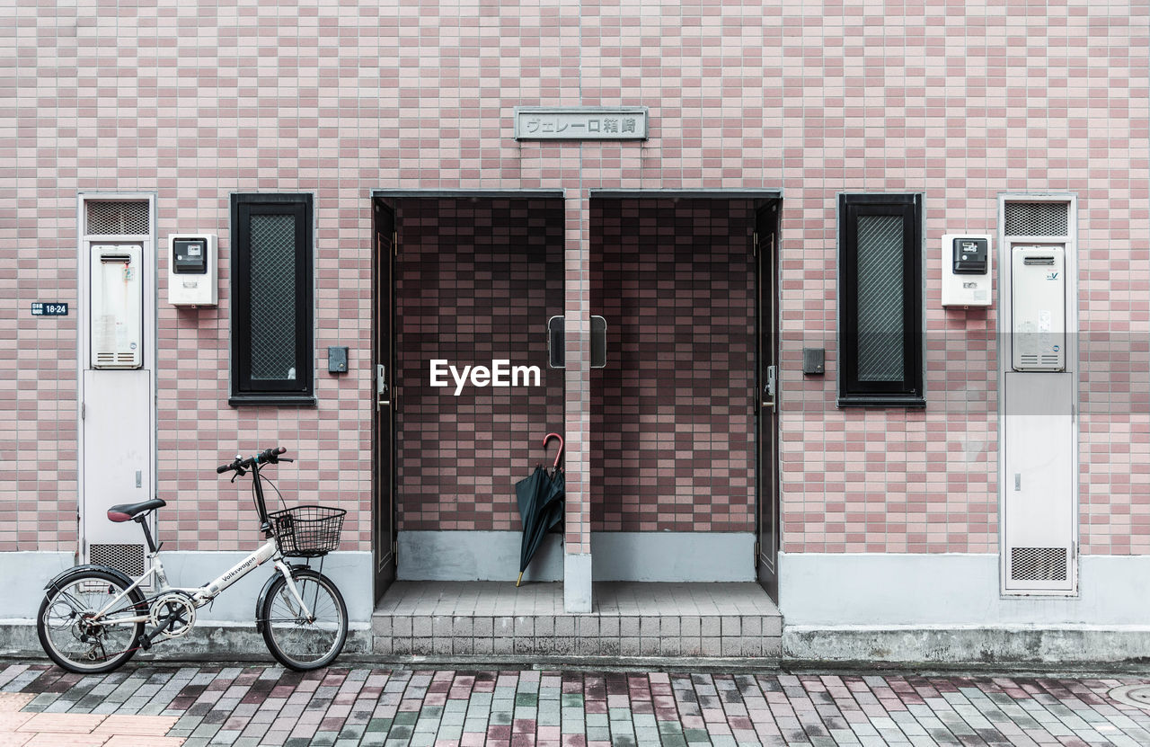 BICYCLES ON SIDEWALK AGAINST WALL