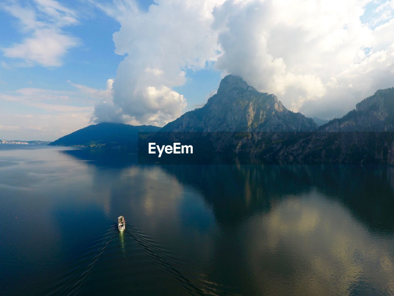 Scenic view of lake by mountains against sky