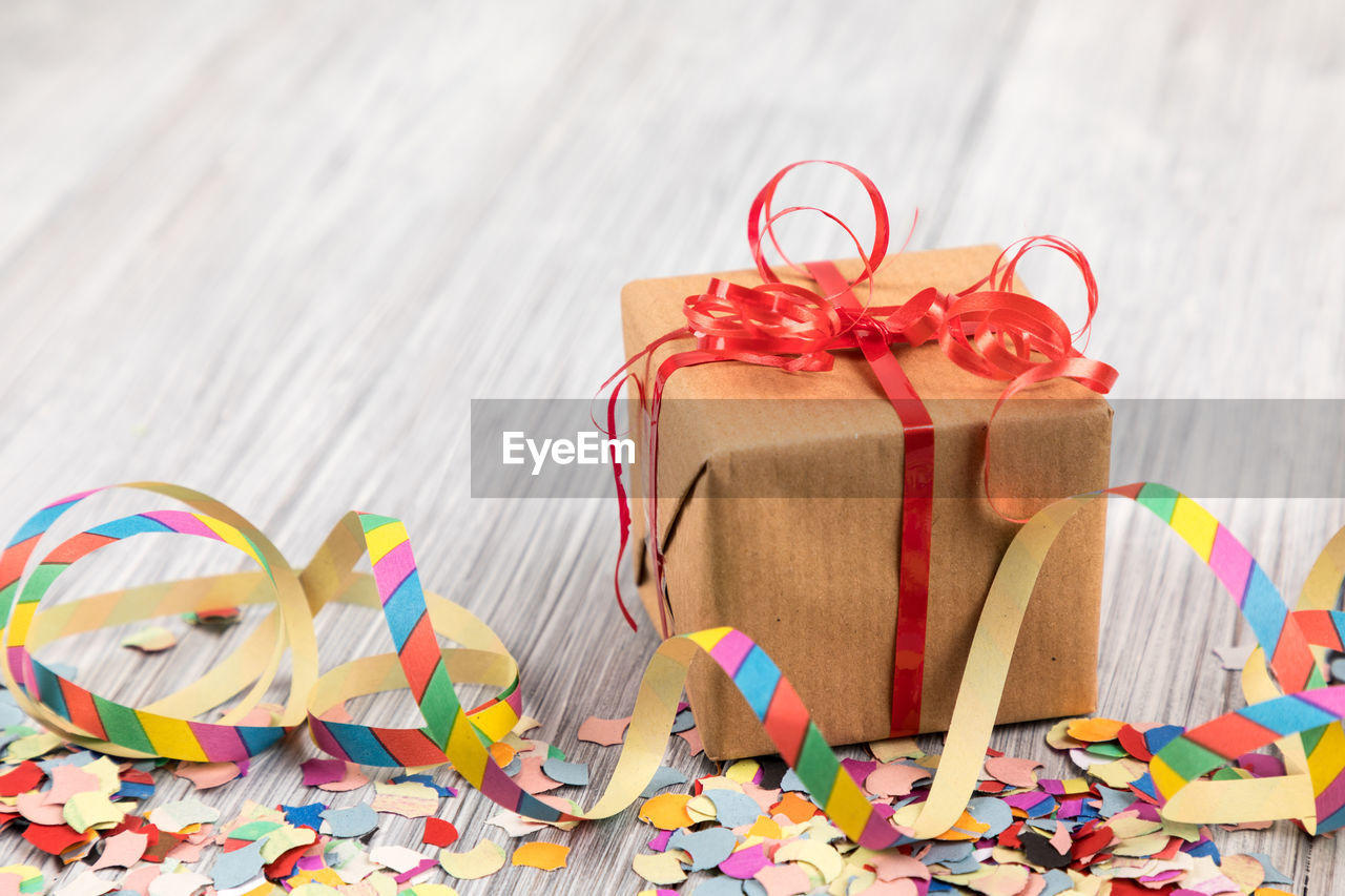 High angle view of multi colored gifts and confetti on table