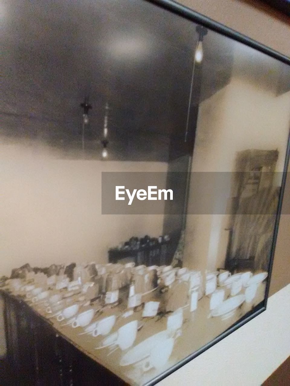 Crockery on table reflecting on mirror