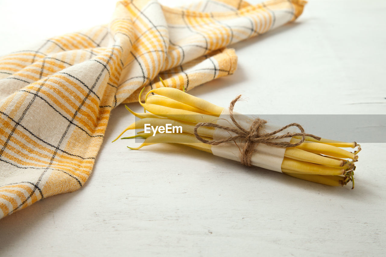 yellow, indoors, food and drink, food, no people, still life, tied up, high angle view, studio shot, wellbeing, pasta, healthy eating, close-up, freshness, italian food, produce, table