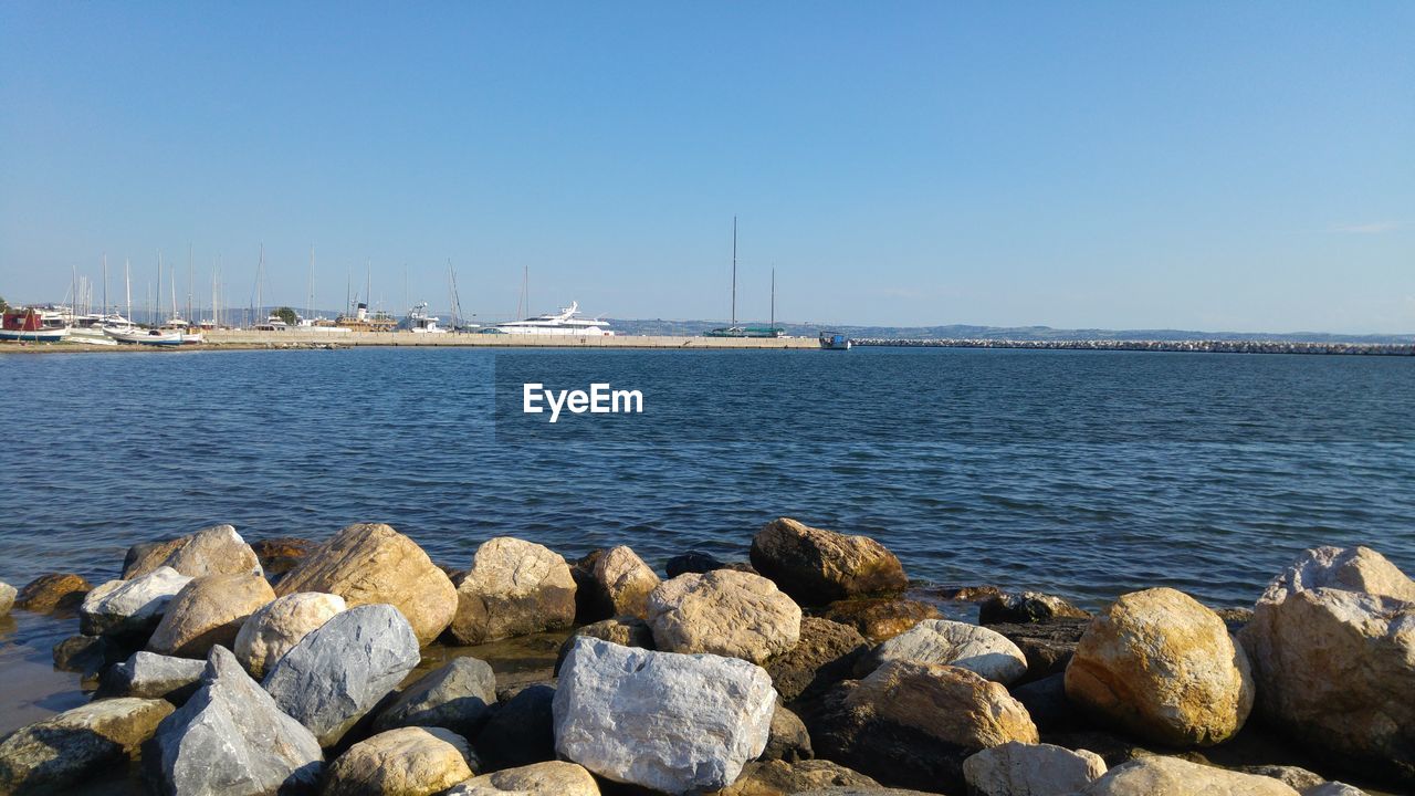 View of boats in sea against clear sky