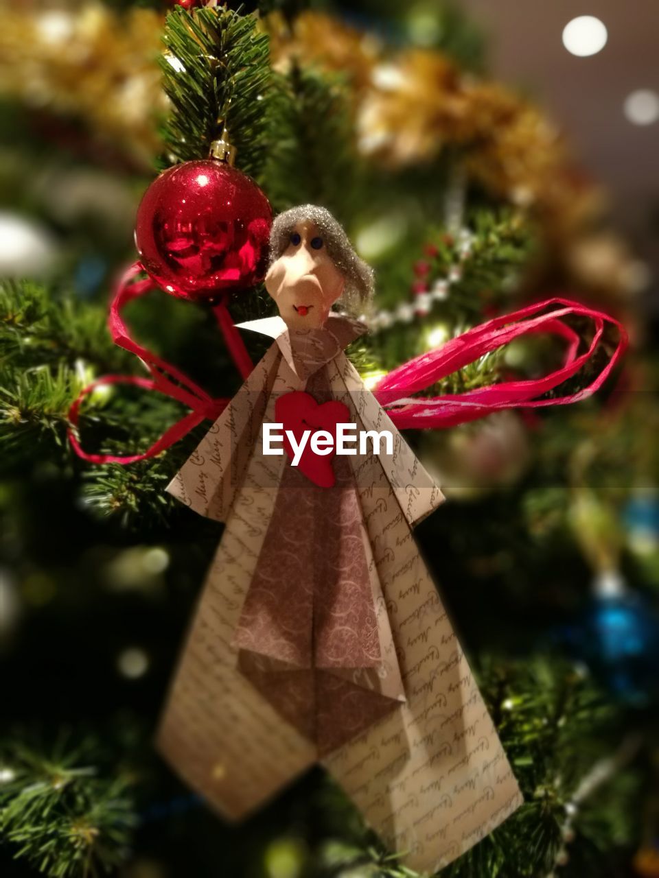 CLOSE-UP OF CHRISTMAS DECORATIONS HANGING ON TREE AT PARK