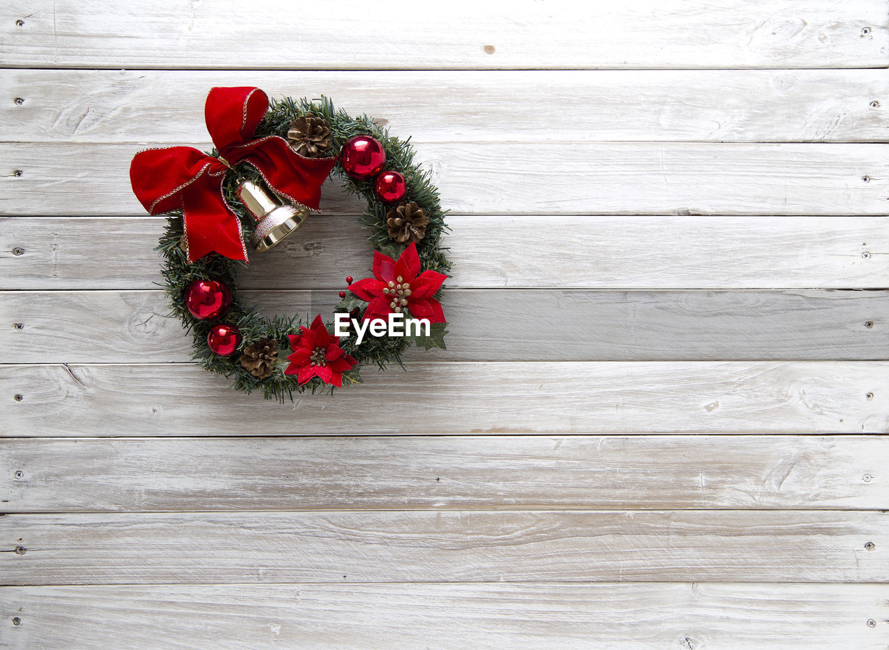 Directly above shot of christmas wreath on hardwood floor