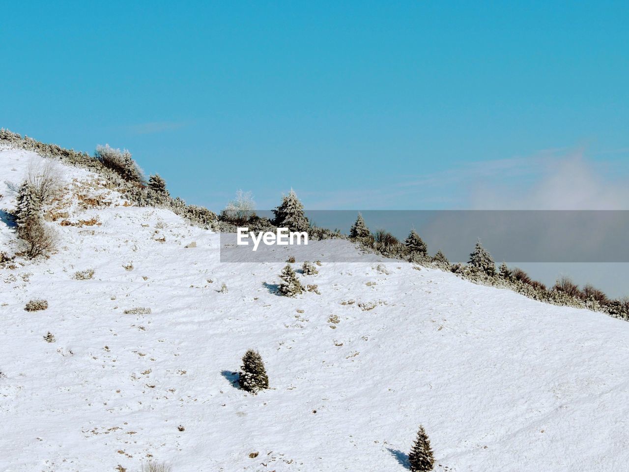 Scenic view of snow covered mountain against sky