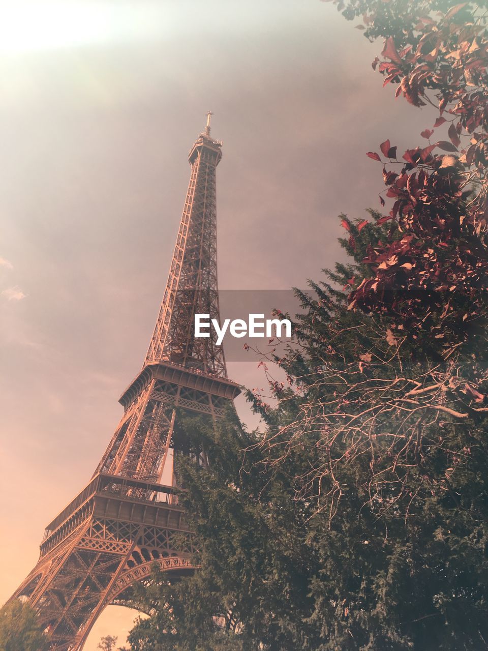 Low angle view of eiffel tower against cloudy sky