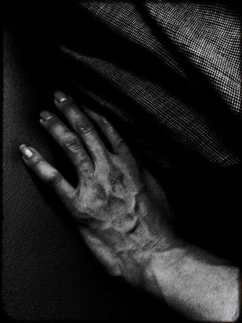 CLOSE-UP OF CROPPED HANDS OVER WHITE BACKGROUND