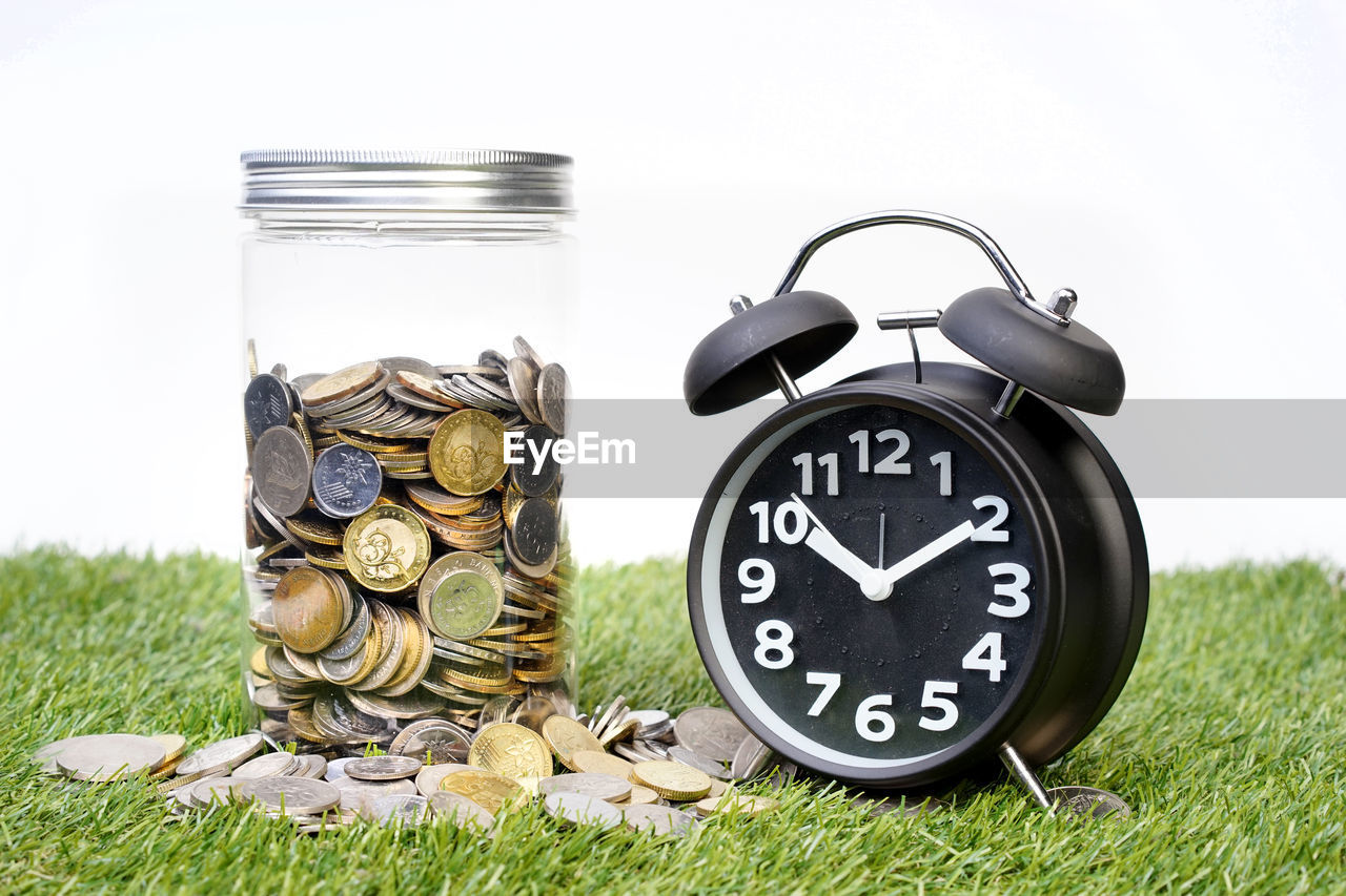 CLOSE-UP OF CLOCK ON FIELD AGAINST WALL