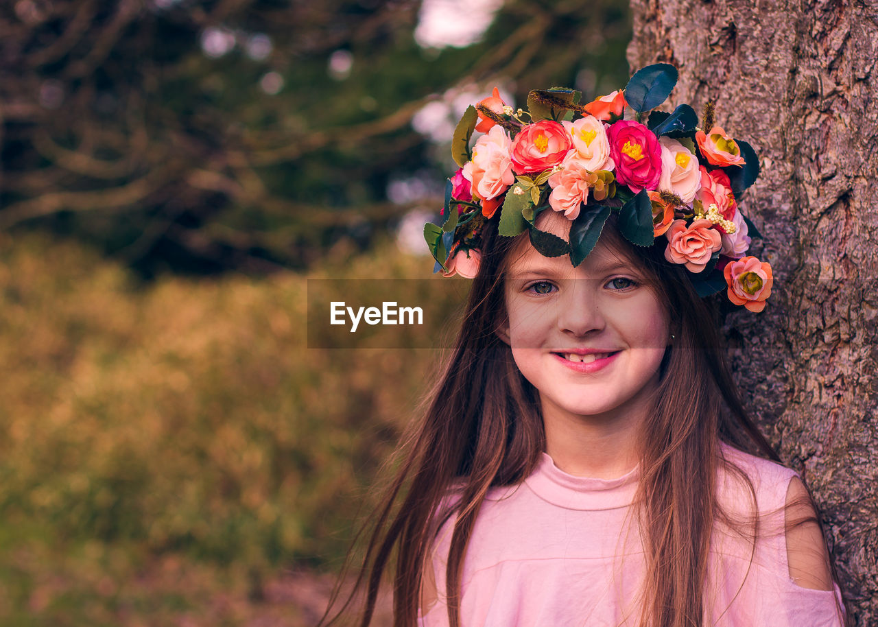 Portrait of smiling girl wearing flowers