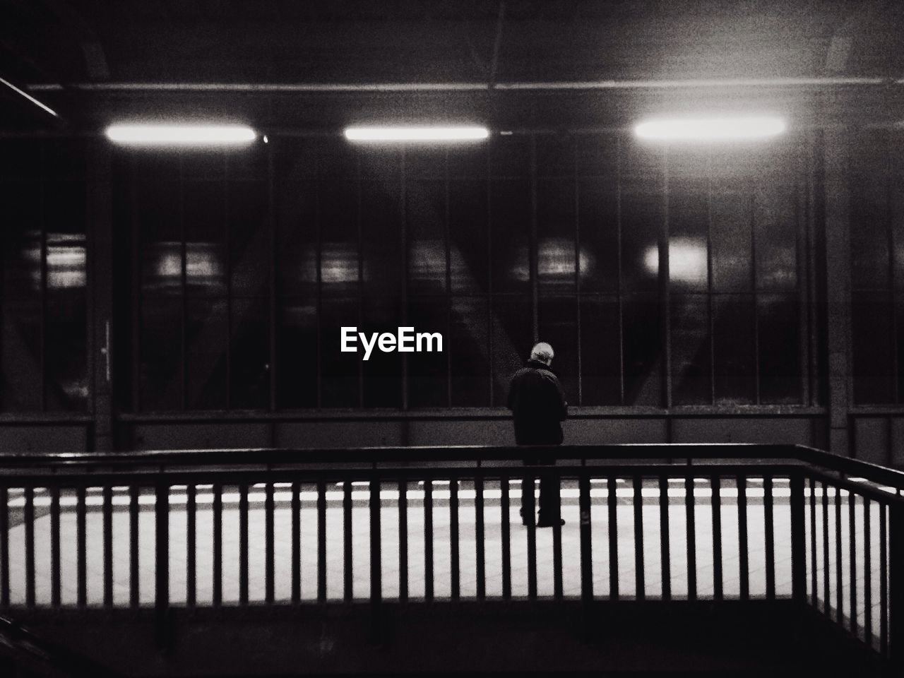 Rear view of man standing on railroad station