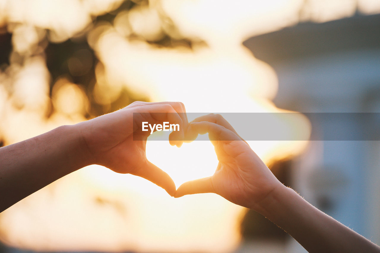 Close-up of hands making heart shape