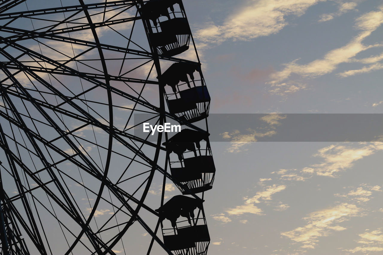 LOW ANGLE VIEW OF WOMAN AGAINST SKY