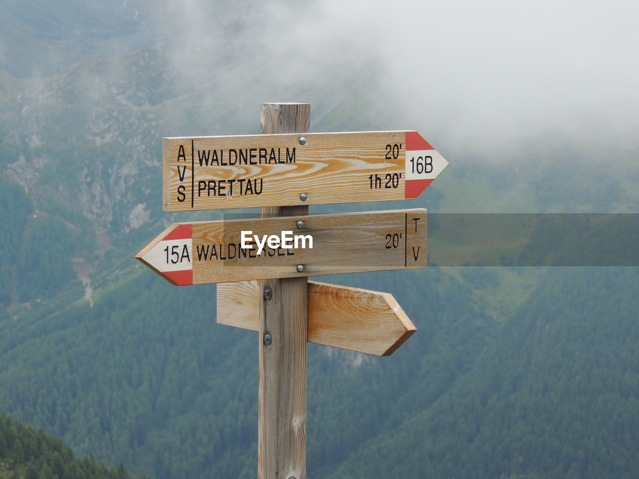 Wooden information signs against mountain