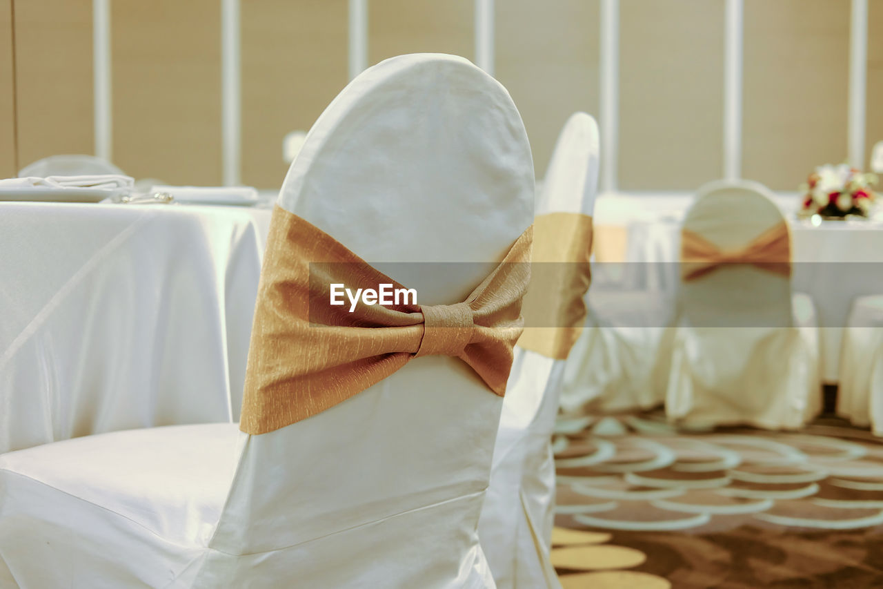 Close-up of chairs by table during wedding ceremony