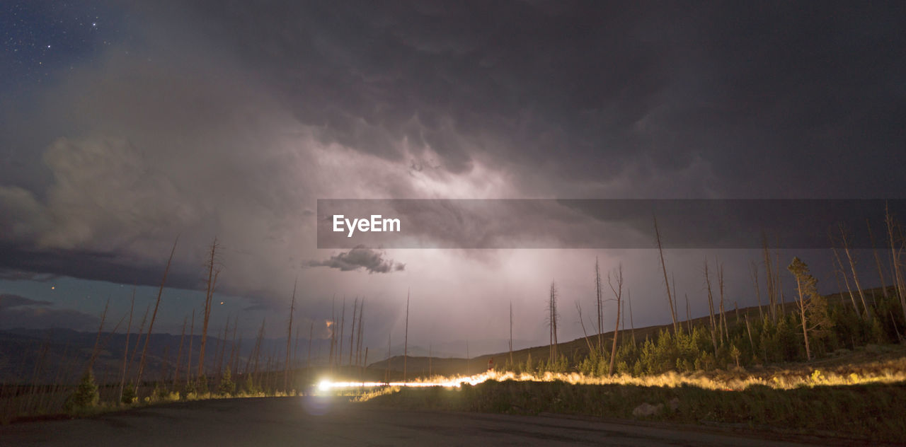 PANORAMIC VIEW OF ROAD AGAINST STORM CLOUDS