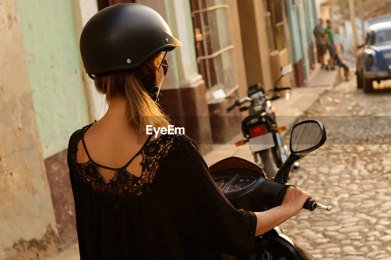 Rear view of woman riding motorcycle