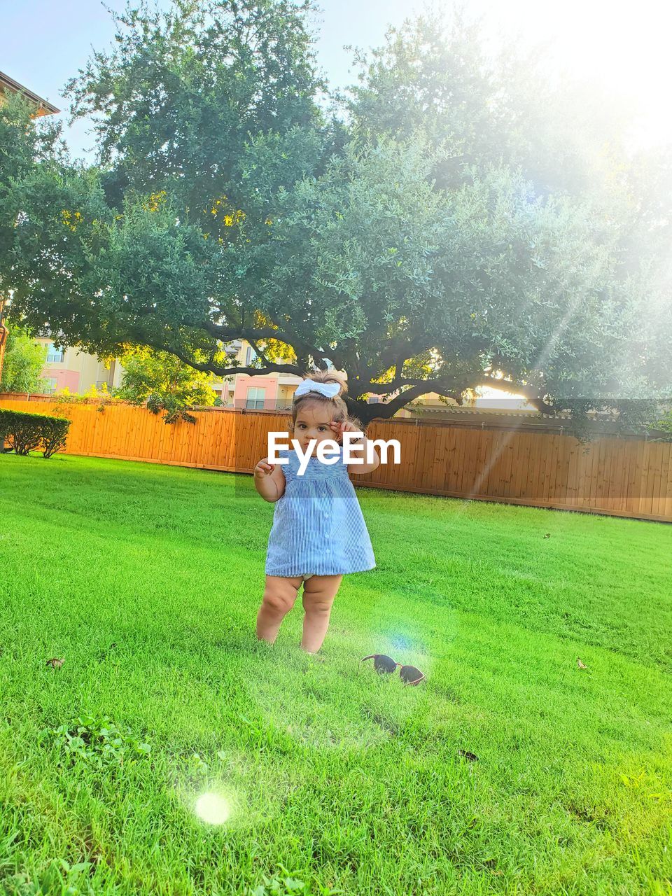 FULL LENGTH OF A BOY STANDING ON GRASS