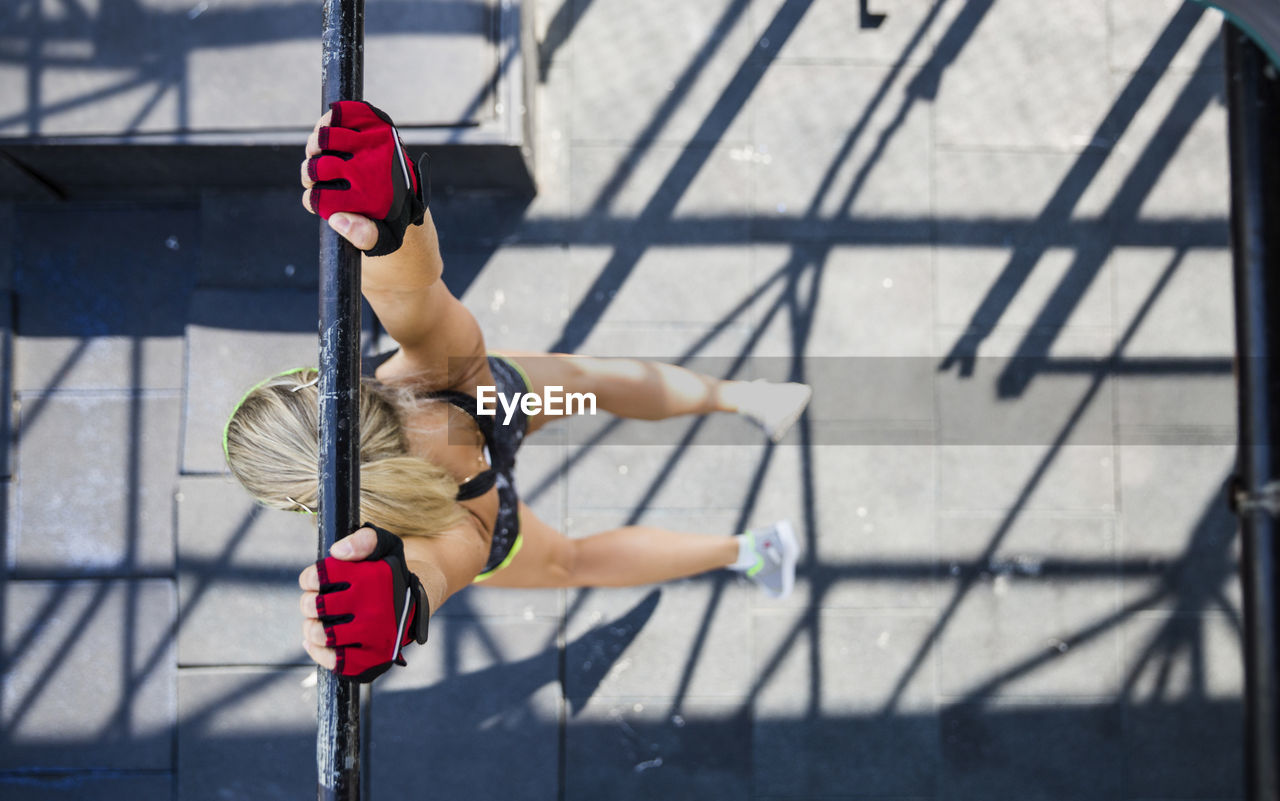 Woman practicing calisthenics at rooftop gym