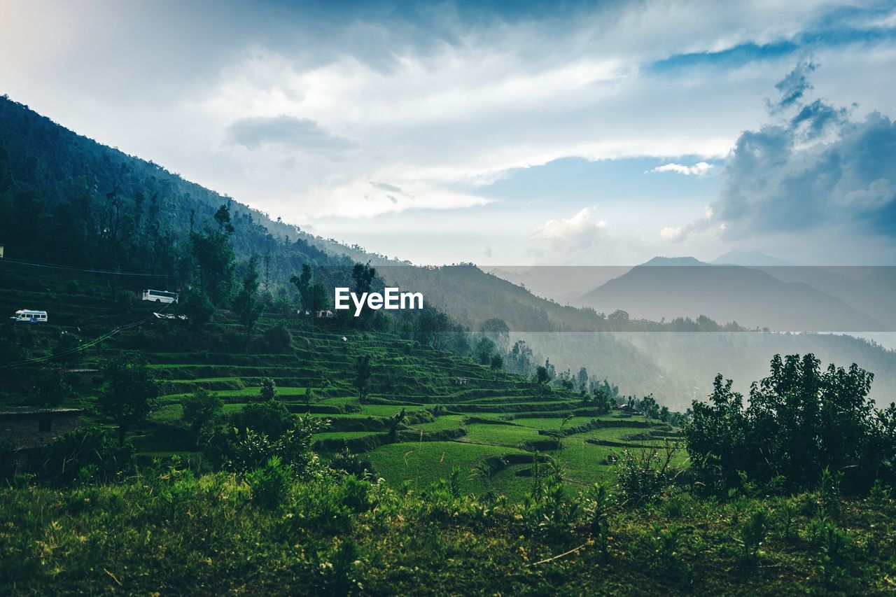 Scenic view of landscape against cloudy sky