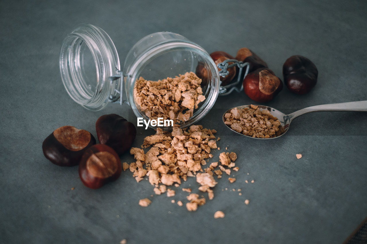 Chestnuts and container on table