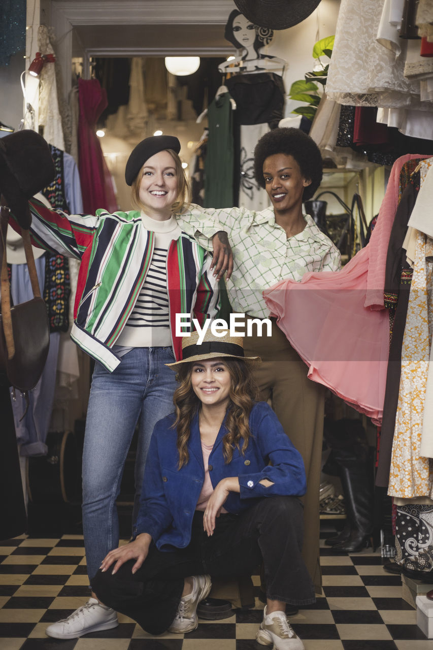 Portrait of smiling female colleagues in clothing store