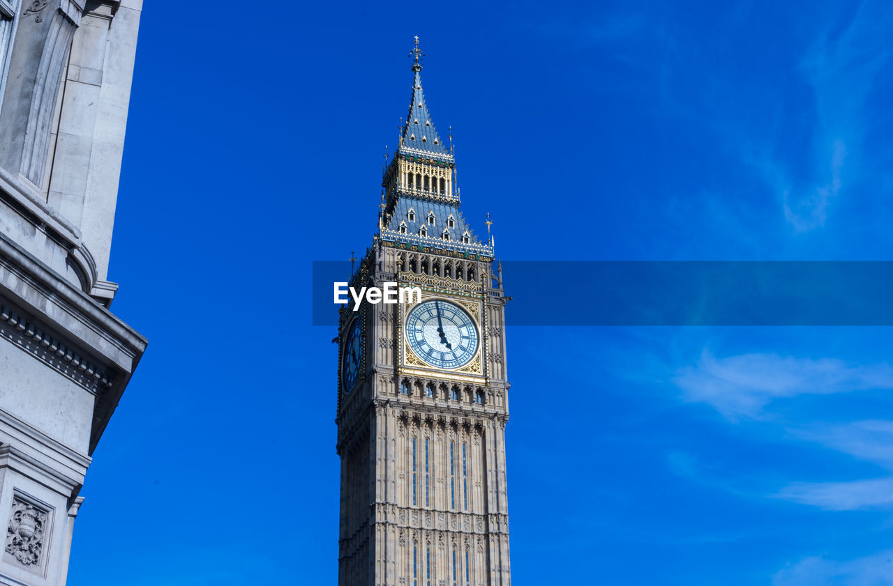 Low angle view of big ben against blue sky