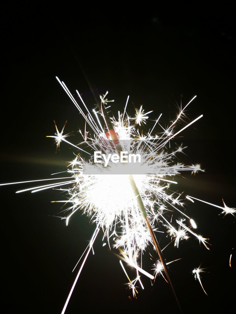 Close-up of sparkler against black background